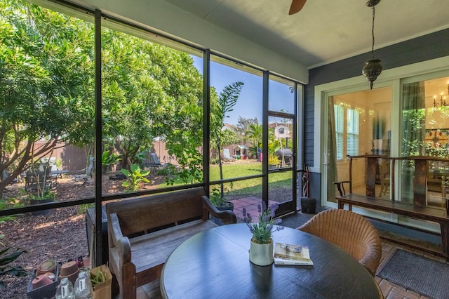 sunroom featuring ceiling fan