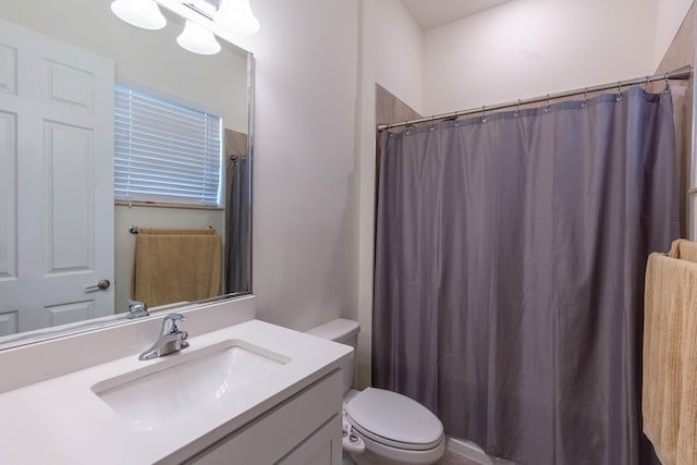 bathroom featuring vanity, a shower with curtain, and toilet