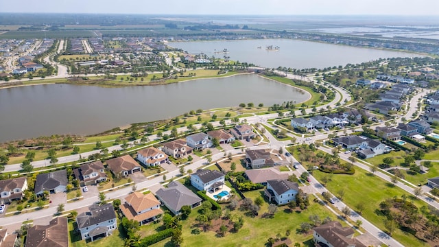 birds eye view of property with a residential view and a water view