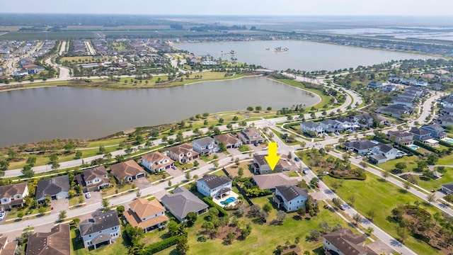 drone / aerial view with a residential view and a water view