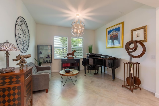 living area with light tile patterned floors, a notable chandelier, and baseboards