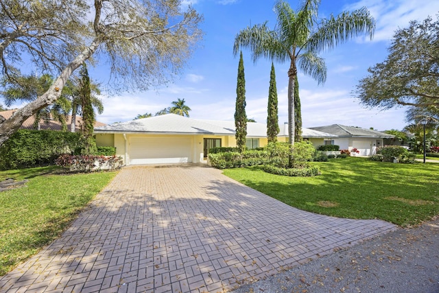 ranch-style home with stucco siding, a front lawn, decorative driveway, a garage, and a tiled roof