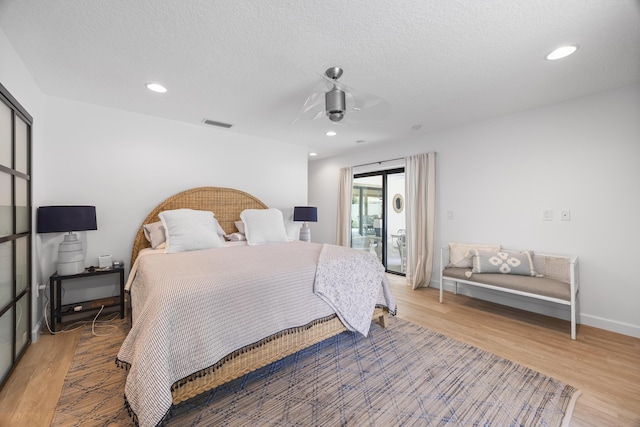 bedroom with access to exterior, light wood-style flooring, recessed lighting, and a ceiling fan