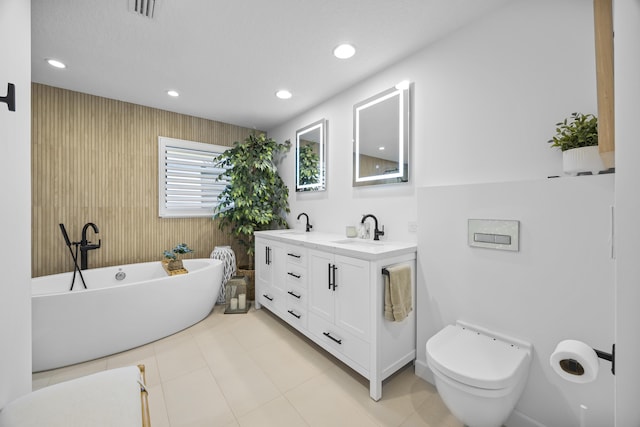 full bathroom featuring visible vents, a soaking tub, double vanity, a sink, and toilet