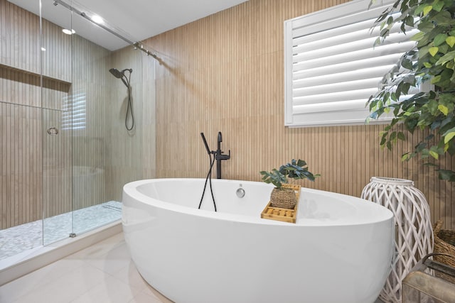 full bath with a shower stall, tile patterned floors, and a freestanding bath