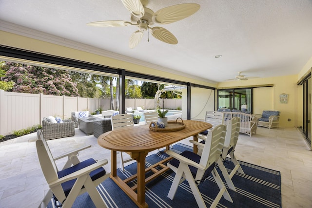 sunroom / solarium with a ceiling fan