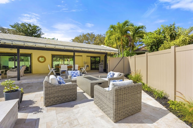 view of patio featuring an outdoor living space with a fire pit, outdoor dining area, and a fenced backyard