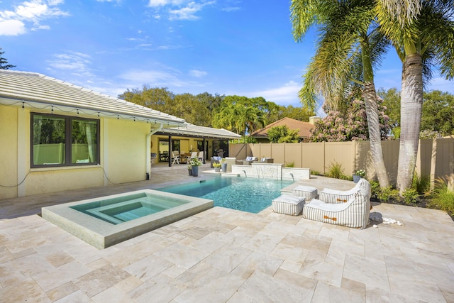 view of pool with a fenced in pool, an in ground hot tub, a fenced backyard, and a patio area