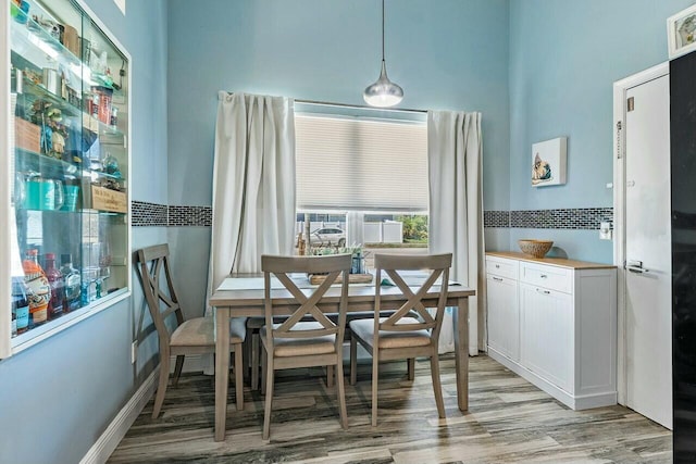 dining space featuring light wood-style floors and breakfast area