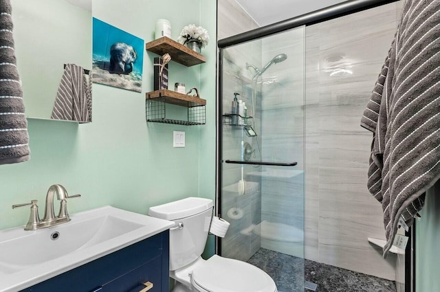 bathroom with vanity, toilet, and a shower stall