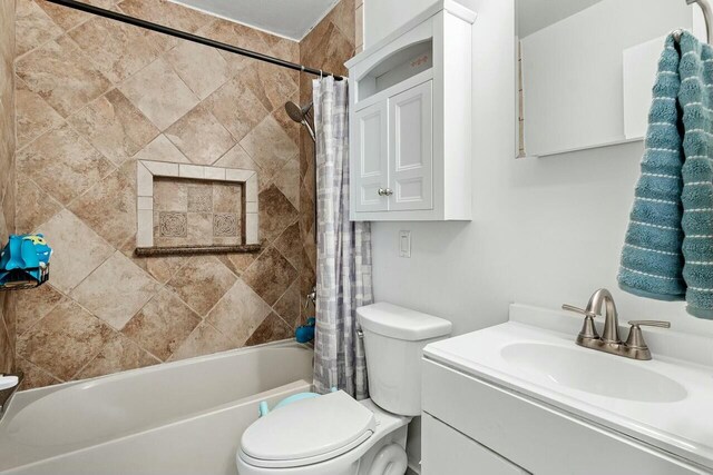 full bathroom featuring vanity, toilet, and shower / tub combo with curtain