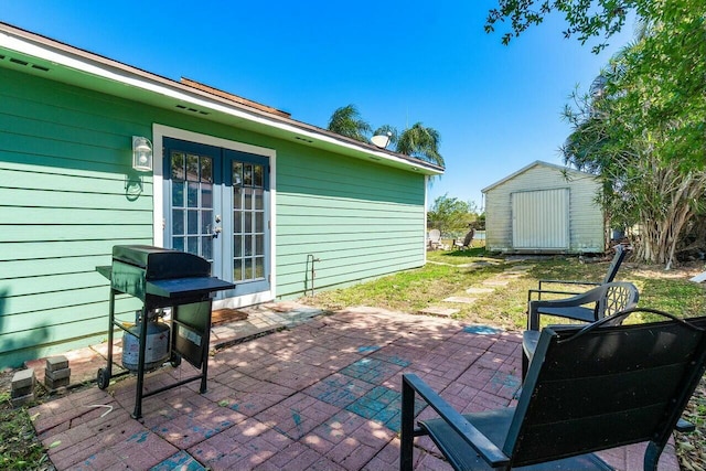 view of patio / terrace with a shed, french doors, an outdoor structure, and area for grilling