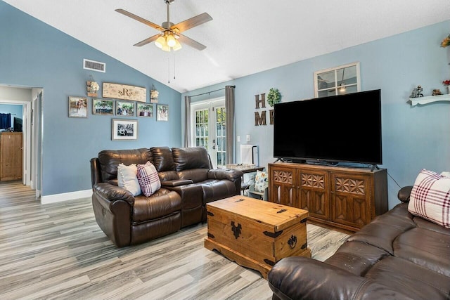 living room with a ceiling fan, visible vents, lofted ceiling, light wood-style flooring, and french doors