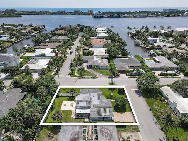 drone / aerial view featuring a water view and a residential view