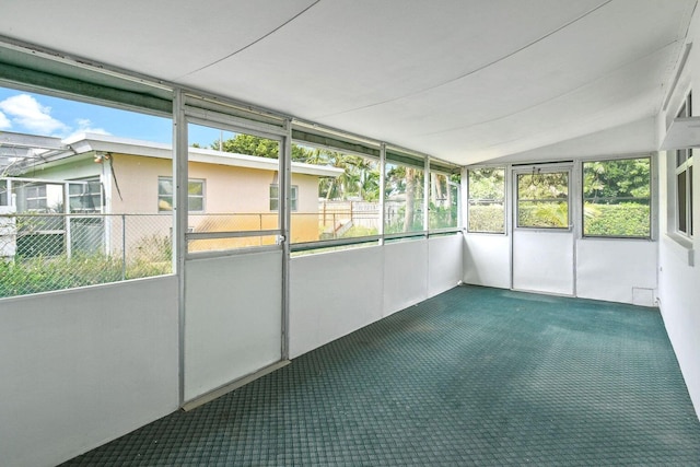 unfurnished sunroom featuring lofted ceiling