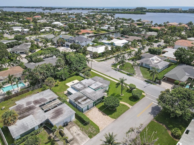 drone / aerial view with a residential view and a water view