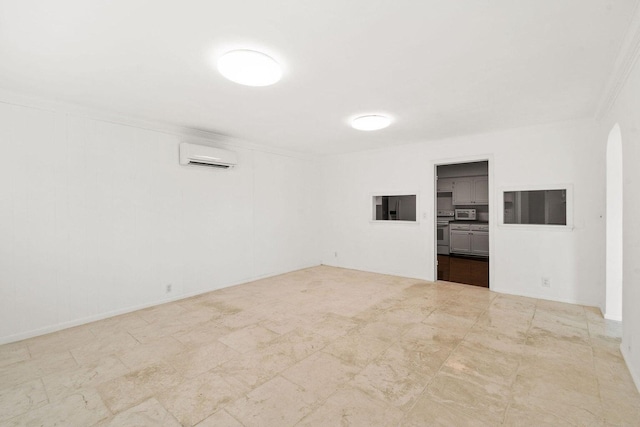 unfurnished room featuring ornamental molding, arched walkways, and a wall mounted AC