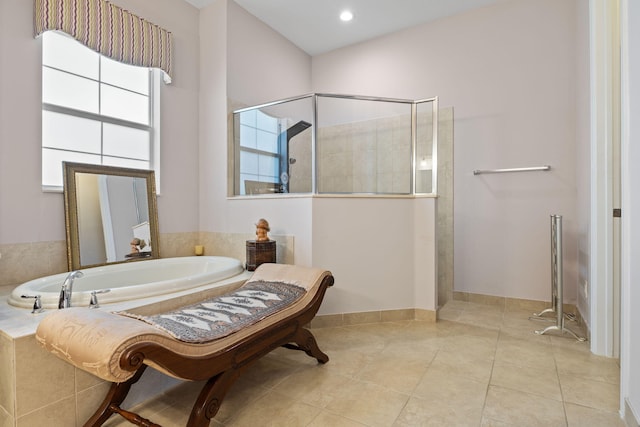 full bathroom with a bath, baseboards, tile patterned flooring, and walk in shower