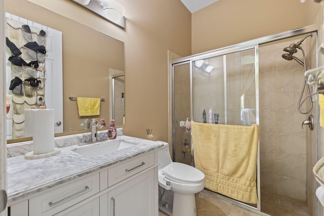 full bathroom with toilet, a stall shower, tile patterned flooring, and vanity