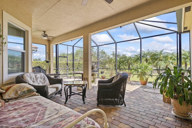 sunroom with a ceiling fan and an outdoor hangout area