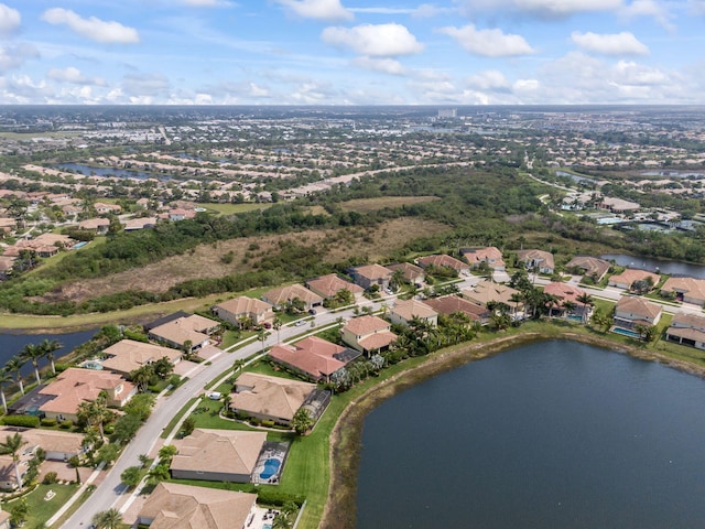 drone / aerial view featuring a residential view and a water view