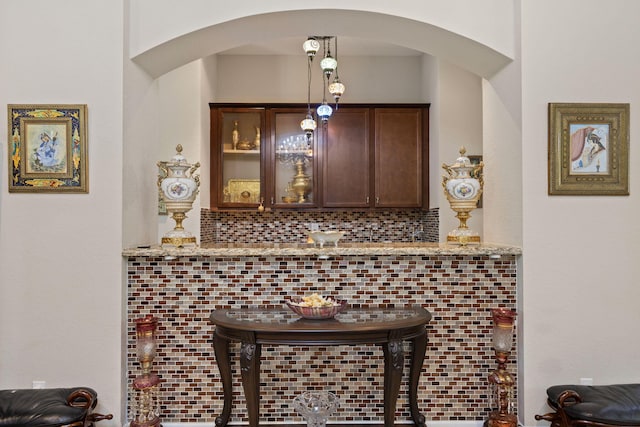 details featuring arched walkways and tasteful backsplash