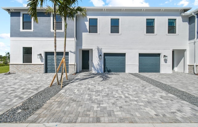 7648 SW Lucy Ln Latitude, Unit Latitude, Stuart, FL 34997 - view of front facade with a garage, stucco siding, and driveway