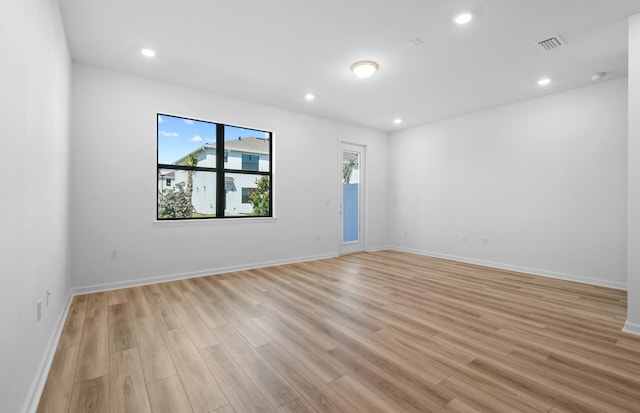7648 SW Lucy Ln Latitude, Unit Latitude, Stuart, FL 34997 - empty room featuring light wood finished floors, recessed lighting, and baseboards