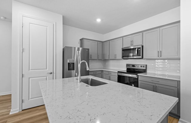 7648 SW Lucy Ln Latitude, Unit Latitude, Stuart, FL 34997 - kitchen with gray cabinetry, stainless steel appliances, a sink, light stone countertops, and recessed lighting