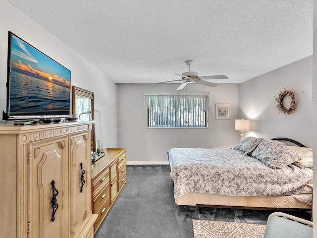 carpeted bedroom featuring a ceiling fan, a textured ceiling, and baseboards