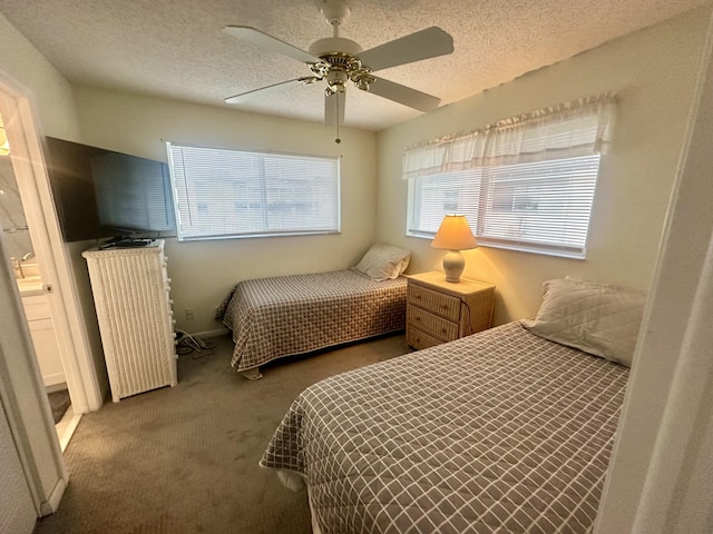 bedroom featuring carpet, ceiling fan, and a textured ceiling