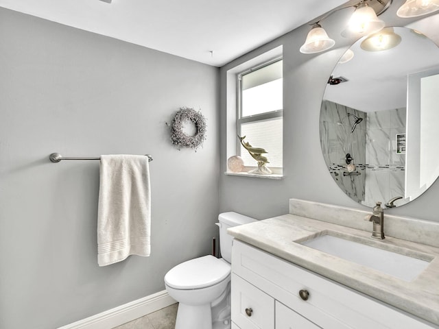 bathroom featuring a marble finish shower, baseboards, toilet, tile patterned flooring, and vanity