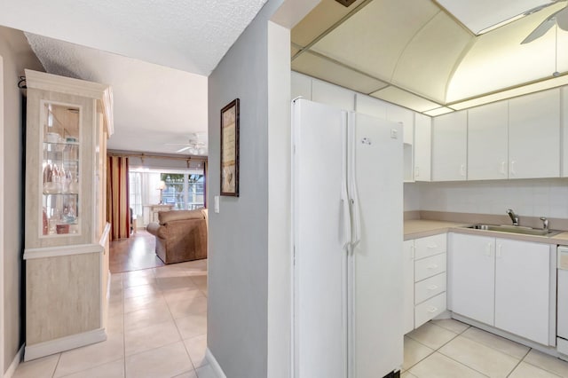 1 Abbey Ln Unit 201, Delray Beach, FL 33446 - kitchen featuring freestanding refrigerator, a ceiling fan, light tile patterned floors, and a sink