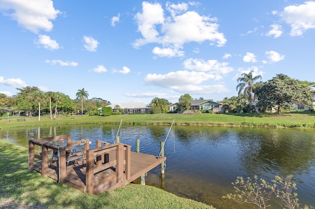 dock area with a yard and a water view