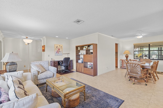 living room with visible vents, crown molding, baseboards, light tile patterned floors, and a textured ceiling