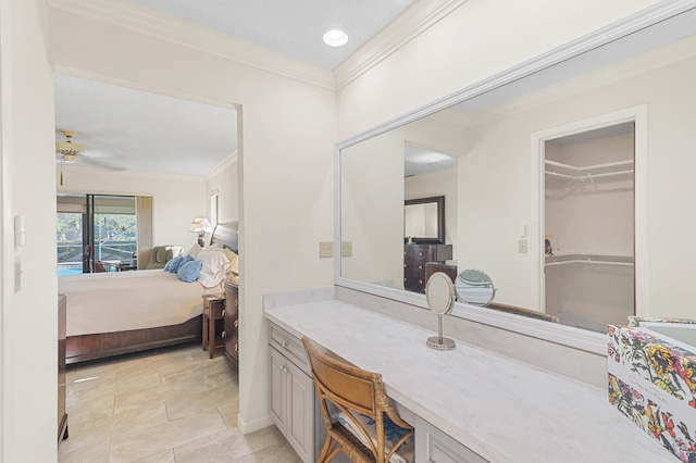 ensuite bathroom featuring ceiling fan, ensuite bath, vanity, and ornamental molding