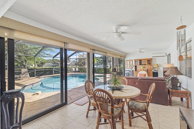 sunroom / solarium featuring a ceiling fan, a pool, and a wall mounted AC