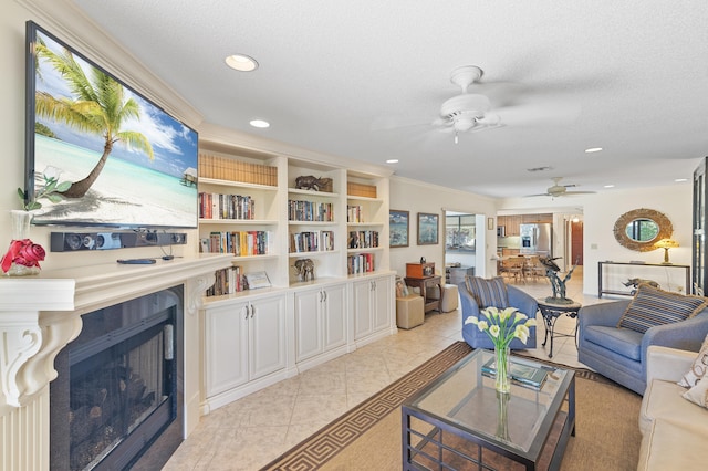 living area with a ceiling fan, a textured ceiling, recessed lighting, a fireplace, and light tile patterned floors