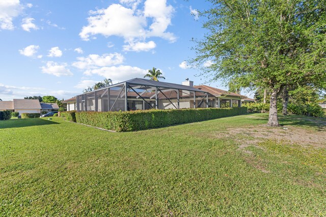 view of yard with glass enclosure