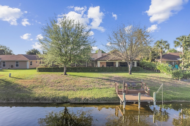 dock area with a yard and a water view