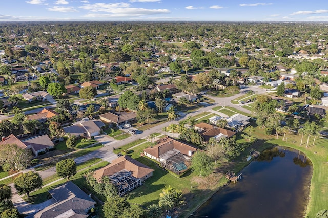 drone / aerial view featuring a residential view and a water view