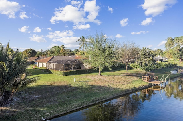 view of dock with a lanai, a yard, and a water view