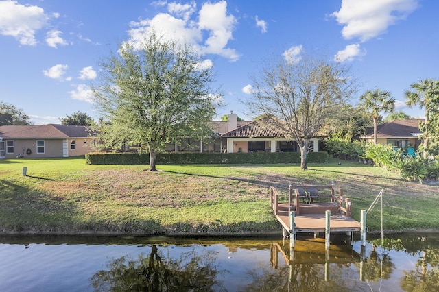 view of dock featuring a water view and a lawn