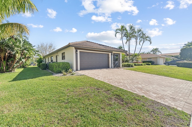 view of front of home with stucco siding, a front lawn, decorative driveway, and a garage