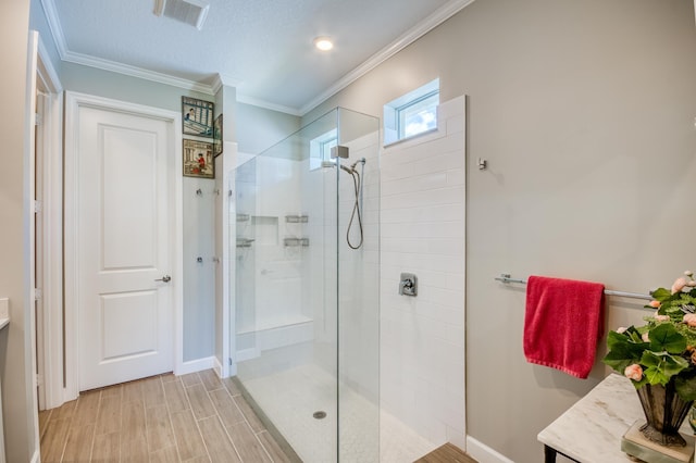 full bath featuring vanity, visible vents, a walk in shower, and ornamental molding