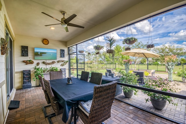 sunroom featuring ceiling fan