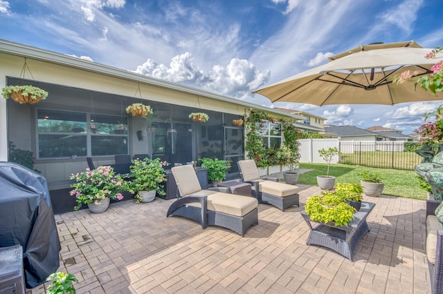 view of patio / terrace with fence, an outdoor living space, and area for grilling