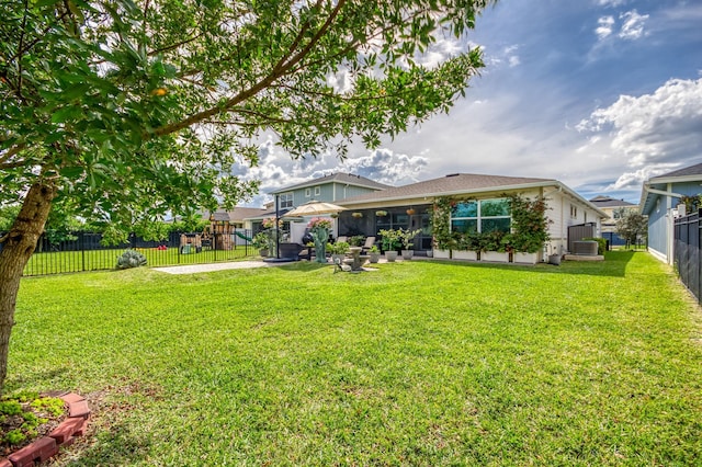 exterior space with a fenced backyard, central AC, and a yard