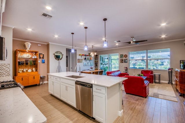 kitchen featuring stainless steel appliances, visible vents, light wood-style flooring, white cabinetry, and a sink