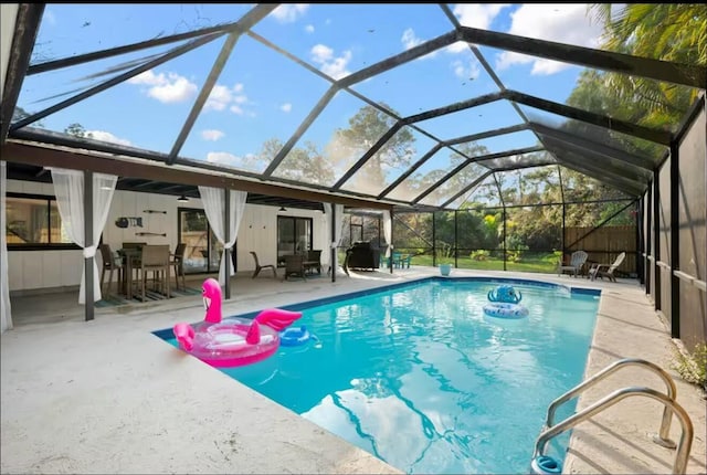 pool with a lanai and a patio